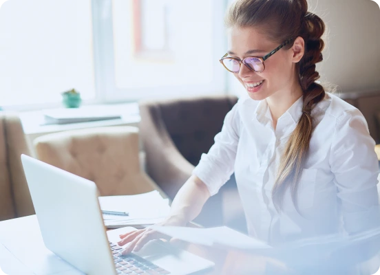 Letting Agent Working on Laptop in Bright Office